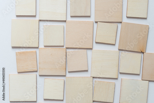 laser cut untreated or natural square wooden shapes arranged on a light background - photographed from above in a flat lay style with ambient light photo