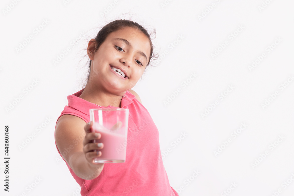 Happy little girl holding a strawberry juice glass Happy little girl holding a strawberry juice glass