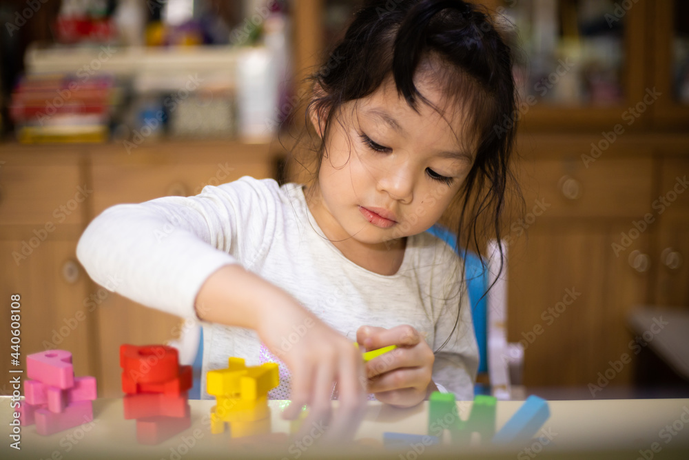 Asian girl learning the alphabets at home. New normal. Covid-19 coronavirus. Social distancing. stay home Asian girl learning the alphabets at home. New normal. Covid-19 coronavirus. Social distancing. stay home