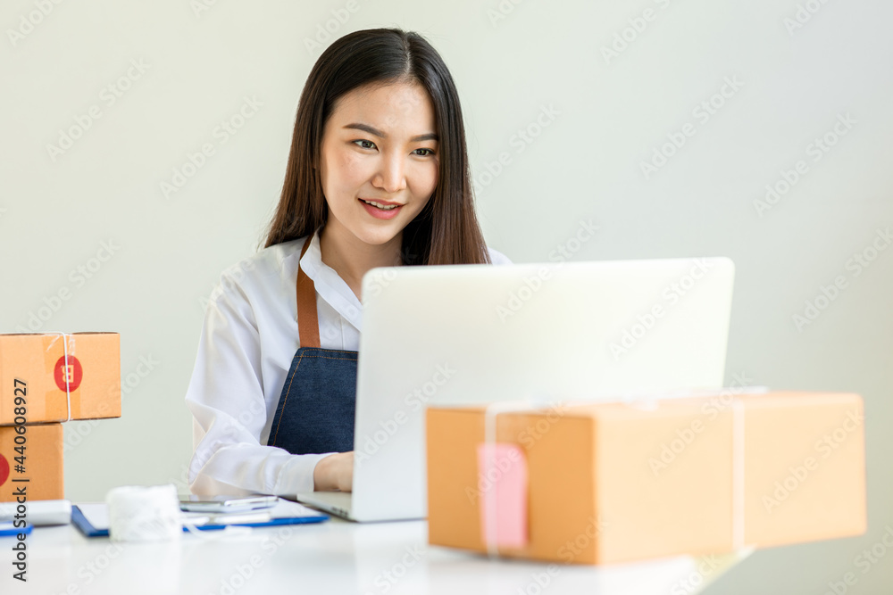 Portrait of Starting small businesses SME owners female entrepreneurs working on receipt box and check online orders to prepare to pack the boxes, sell to customers, sme business ideas online. Portrait of Starting small businesses SME owners female entrepreneurs working on receipt box and check online orders to prepare to pack the boxes, sell to customers, sme business ideas online.