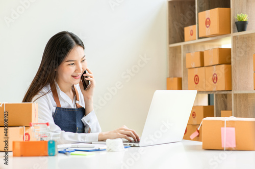 Portrait of Starting small businesses SME owners female entrepreneurs working on receipt box and check online orders to prepare to pack the boxes, sell to customers, sme business ideas online.