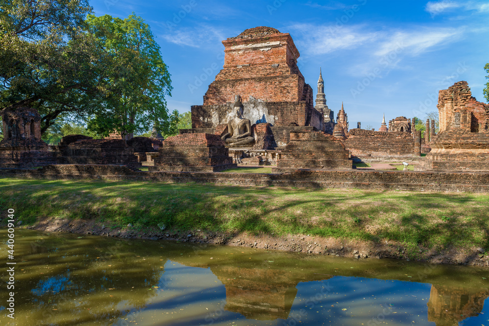 Sunny day on the ancient ruins of the Buddhist temple of Wat Mahathat. Sukhothai, Thailand