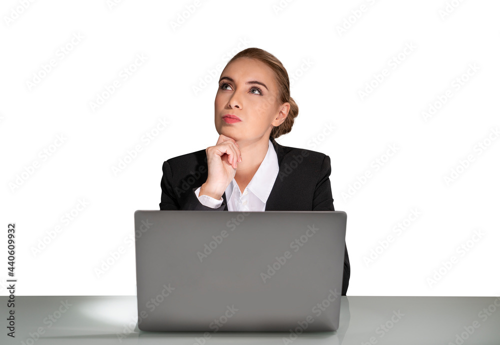 Portrait of attractive dreaming young business woman in formal clothes isolated on white background sitting on desk and working on laptop. Concept of corporate lifestyle. Portrait of attractive dreaming young business woman in formal clothes isolated on white background sitting on desk and working on laptop. Concept of corporate lifestyle.