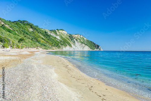 The beach of Mezzavalle view from above unique bay in Conero natural park dramatic coast headland rock cliff adriatic sea Italy turquoise transparent water