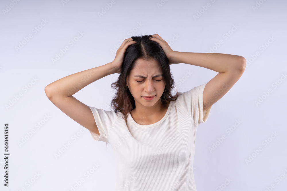Portrait of Asian woman with headache isolated on white background Portrait of Asian woman with headache isolated on white background