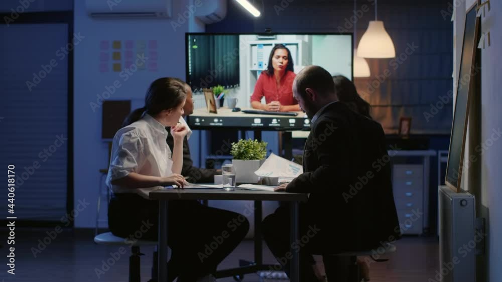Diverse multi ethnic teamwork having online videocall conference working at management strategy in meeting room late at night. Focused coworkers discussing brainstorming ideas Diverse multi ethnic teamwork having online videocall conference working at management strategy in meeting room late at night. Focused coworkers discussing brainstorming ideas