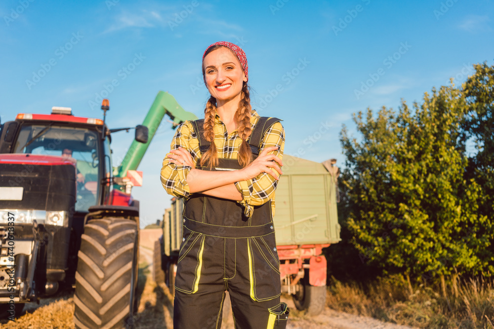 Proud famer standing in front of agricultural machinery arms crossed Proud famer standing in front of agricultural machinery arms crossed