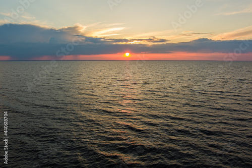 sunset over the sea with many waves photo