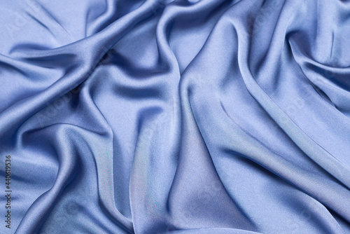 Blue silk or satin luxury fabric texture. Top view.