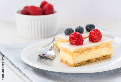 Traditional swiss custard slices with icing  Cremeschnitte in German  with fresh berries  close up