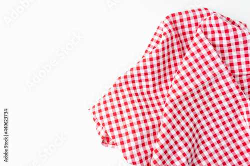A crumpled dining tablecloth with a white and red checker isolated pattern is placed on a white background. Top view for food menu design. Used to cover the dining table, for easy to clean the table.