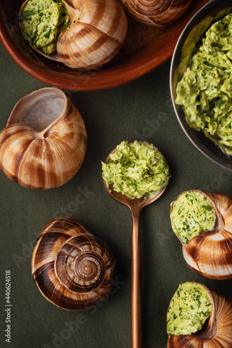 escargot stuffed in sauce on a green table