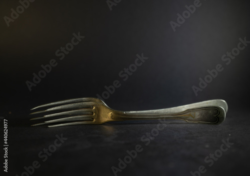 Old silver forks on differtnt background