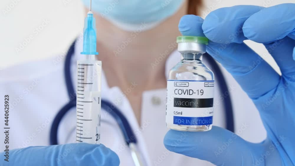 COVID-19 Vaccine in Researcher Hands, Doctor's Hand Holds a Syringe and a Vaccine Bottle at the Hospital. New Medication Developing, Vaccination. Prevention of flu. High quality 4k footage COVID-19 Vaccine in Researcher Hands, Doctor's Hand Holds a Syringe and a Vaccine Bottle at the Hospital. New Medication Developing, Vaccination. Prevention of flu. High quality 4k footage