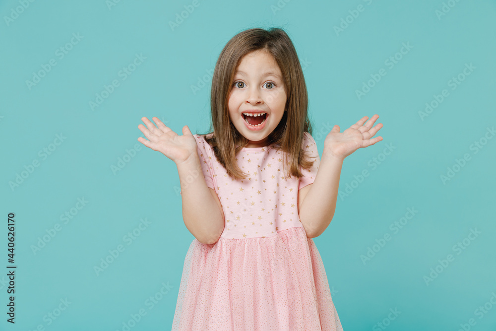 Little shocked cute kid girl 5-6 years old wears pink dress have fun spread hands open mouth isolated on pastel blue color background child studio. Mother's Day love family people lifestyle concept. Little shocked cute kid girl 5-6 years old wears pink dress have fun spread hands open mouth isolated on pastel blue color background child studio. Mother's Day love family people lifestyle concept.