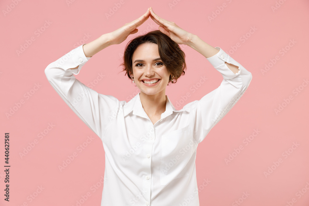 Young successful employee business woman corporate lawyer in classic formal white shirt work in office hold folded hands above head like house roof stay home isolated on pastel pink color background. Young successful employee business woman corporate lawyer in classic formal white shirt work in office hold folded hands above head like house roof stay home isolated on pastel pink color background.