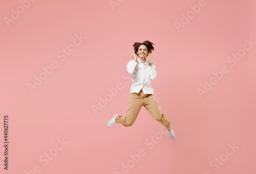 Full length surprised overjoyed young happy successful employee business woman 20s corporate lawyer in classic formal white shirt work in office hold face jump high isolated on pastel pink background