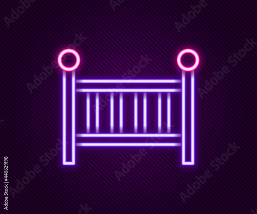 Glowing neon line Baby crib cradle bed icon isolated on black background. Colorful outline concept. Vector