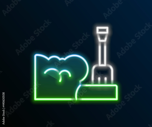 Glowing neon line Shovel in snowdrift icon isolated on black background. Colorful outline concept. Vector