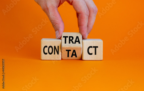 From contact to contract symbol. Businessman turns the wooden cube and changes the word 'contact' to 'contract'. Beautiful orange background, copy space. Business, from contact to contract concept.