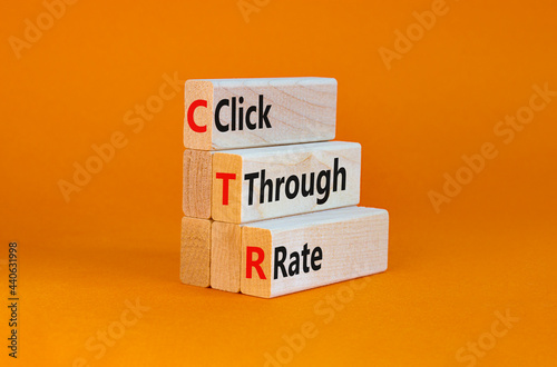 CTR click through rate symbol. Wooden blocks with words 'CTR click through rate'. Beautiful orange background. Business and CTR click through rate concept. Copy space. photo