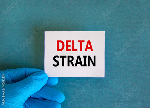 New covid-19 delta variant strain symbol. Doctor hand in blue glove with white card. Concept words 'delta strain'. Medical and COVID-19 delta variant strain concept. Copy space.