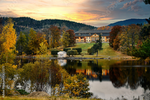 Old mansion above a lake. Beautiful autumn forest surrounding the old house. Old Norwegian mansion. Bogstad gård. 