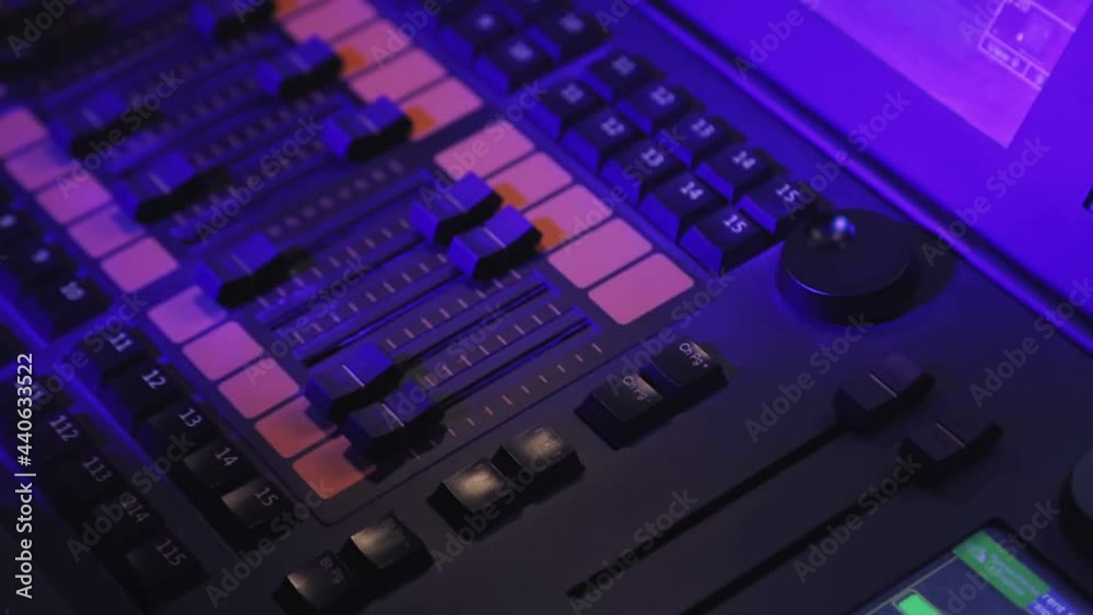Hand A woman lighting designer at the console controls the lighting fixtures Hand A woman lighting designer at the console controls the lighting fixtures