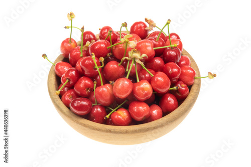 red cherries in a wooden bowlprice white isolated background