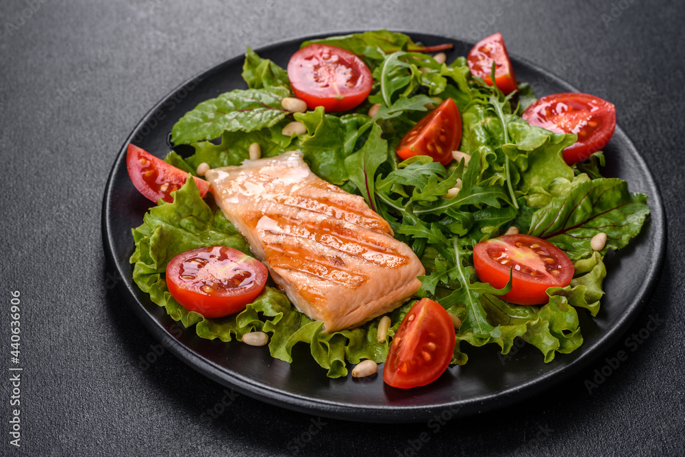 Delicious fresh salad with fish, tomatoes and lettuce leaves Delicious fresh salad with fish, tomatoes and lettuce leaves