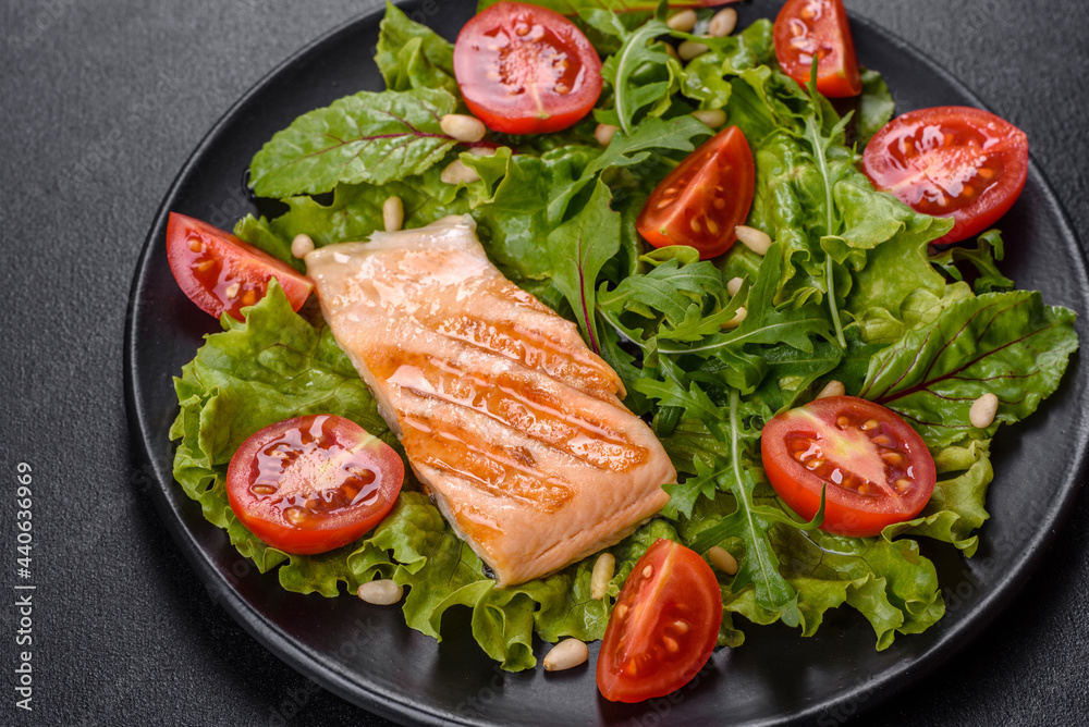 Delicious fresh salad with fish, tomatoes and lettuce leaves Delicious fresh salad with fish, tomatoes and lettuce leaves