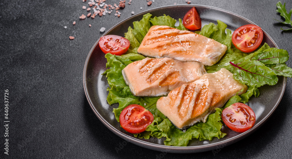Delicious fresh salad with fish, tomatoes and lettuce leaves Delicious fresh salad with fish, tomatoes and lettuce leaves