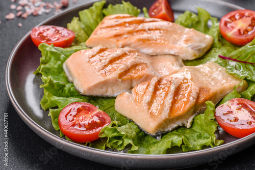 Delicious fresh salad with fish, tomatoes and lettuce leaves