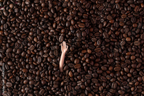 A hand sending a greeting from roasted coffee. Flat lay. Drink concept