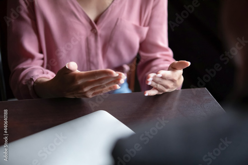 Close up young woman gesturing  involved in interesting conversation at meeting with friend in cafe. Female job applicant answer questions of hr manager  passing job interview  staffing process.