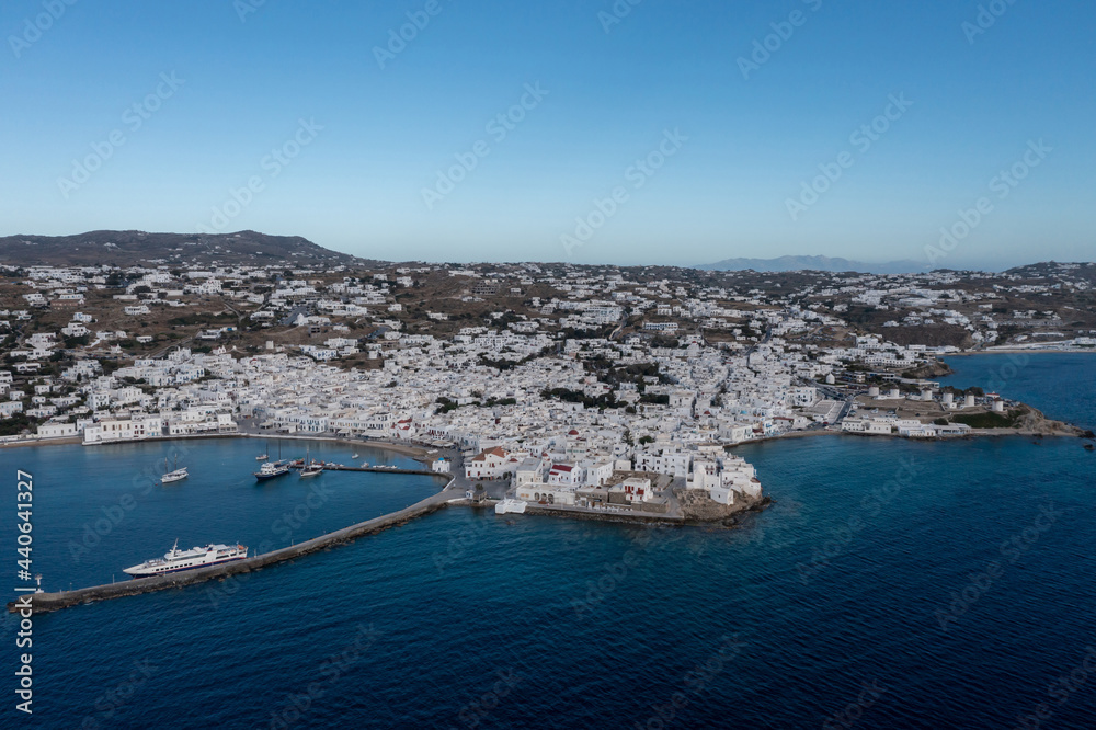 Greece, Mikonos island, Cyclades. Aerial drone view. Mikonos Chora whitewashed buildings cityscape, port and coastline.