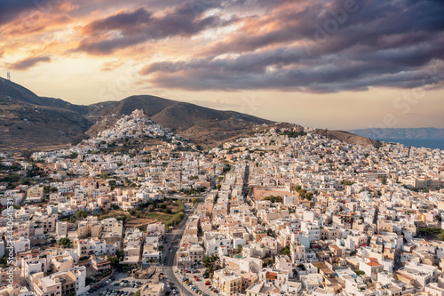 Syros island, Greece, aerial drone view. Ermoupolis and Ano Siros town cityscape, cloudy sky at sunset © Rawf8