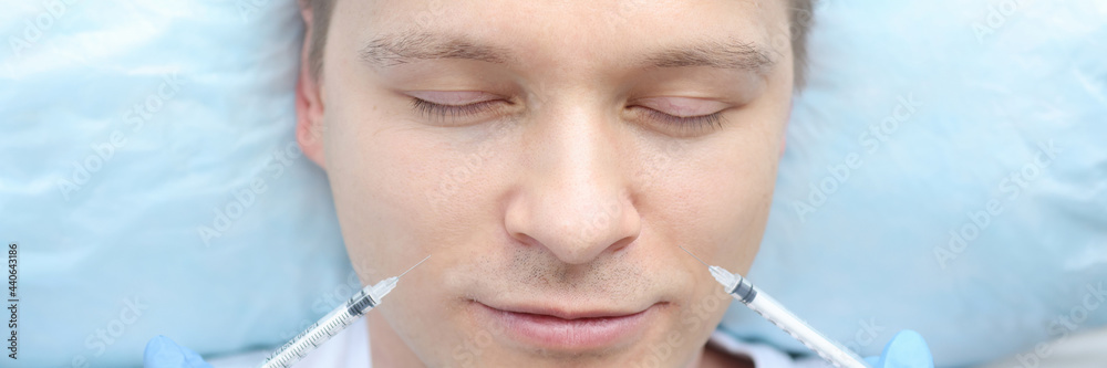 Fototapeta premium Male patient is given multiple injections into facial skin