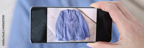 Photography Woman photographing blue jacket on camera phone closeup