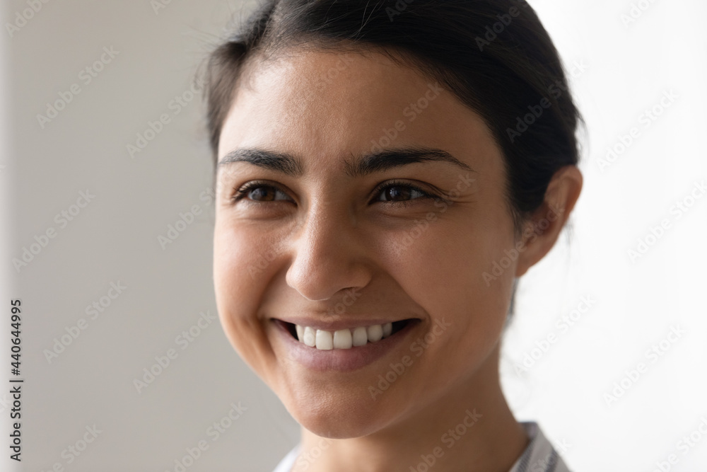 Close up side view of smiling young Indian woman look in distance think dream of career success achievement. Happy mixed race ethnicity female imagine or make plan, visualize. Vision concept. Close up side view of smiling young Indian woman look in distance think dream of career success achievement. Happy mixed race ethnicity female imagine or make plan, visualize. Vision concept.
