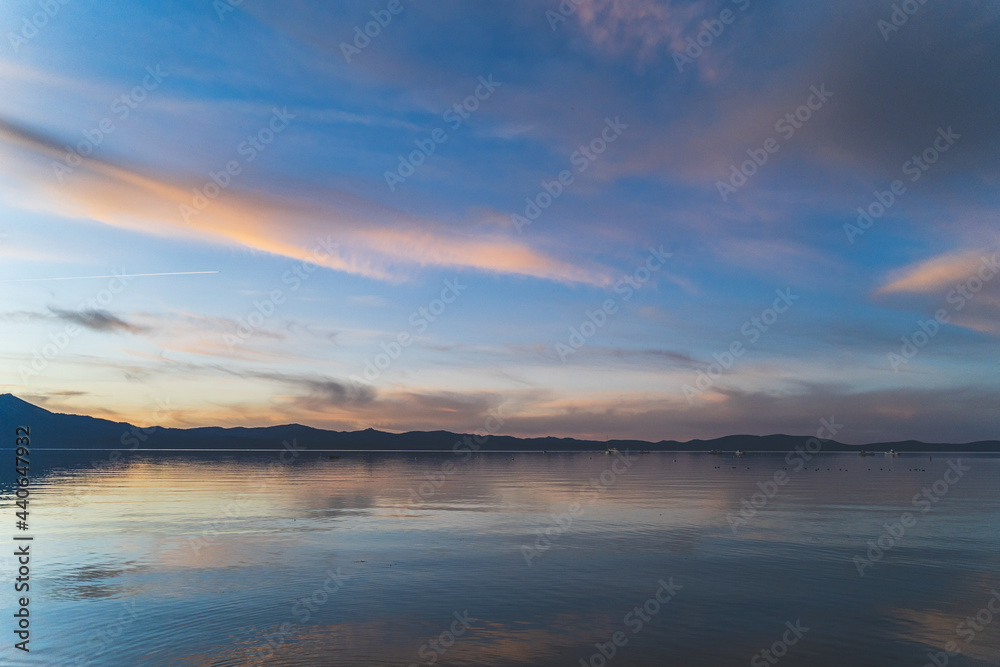 Colorful clouds reflecting in water over Lake Tahoe California after sunset