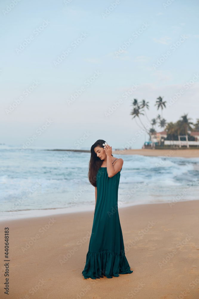 Portrait of beautiful young woman in dress on the beach. Pretty girl on tropical beach. Freedom concept, holiday, beach, sky background. Portrait of beautiful young woman in dress on the beach. Pretty girl on tropical beach. Freedom concept, holiday, beach, sky background.