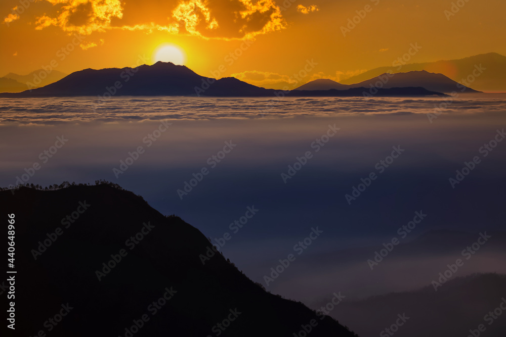 The morning sun and the orange sky above the mountains. Twilight sky background. Colorful Sunset sky and cloud. vivid sky in twilight time background. Fiery orange sunset  Beautiful.