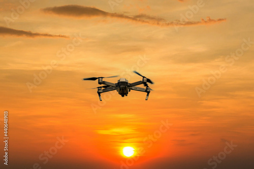 Drone copter flying with digital camera. Drone with high resolution digital camera. Flying camera take a photo and video. The drone with professional camera takes pictures of the misty mountains