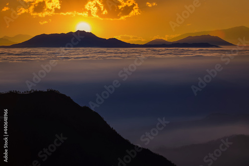 The morning sun and the orange sky above the mountains. Twilight sky background. Colorful Sunset sky and cloud. vivid sky in twilight time background. Fiery orange sunset Beautiful.