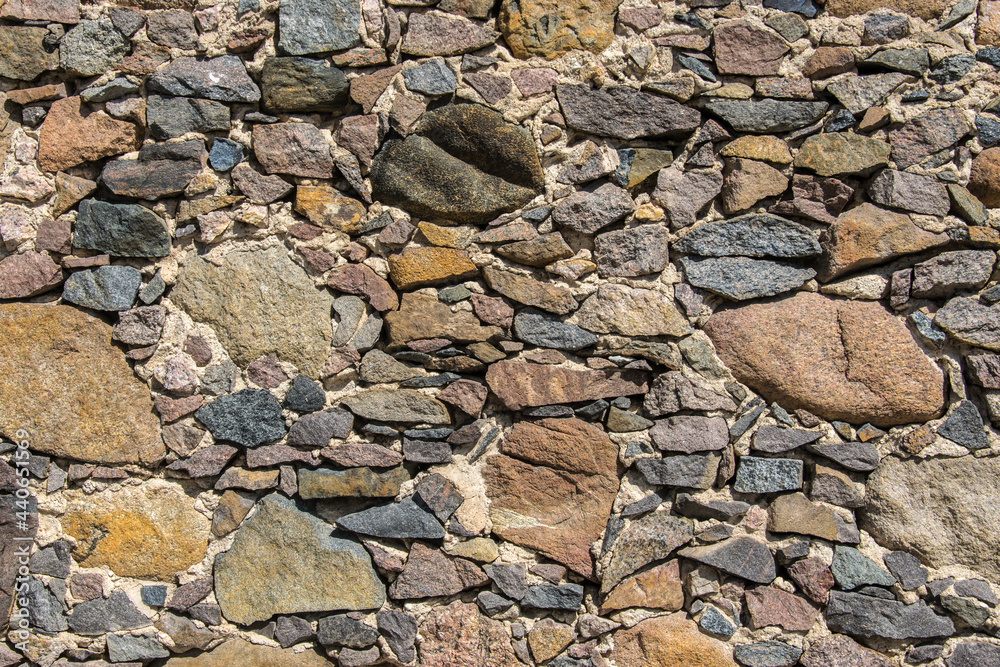 Fototapeta premium Detail of a stone wall with different size of rocks.