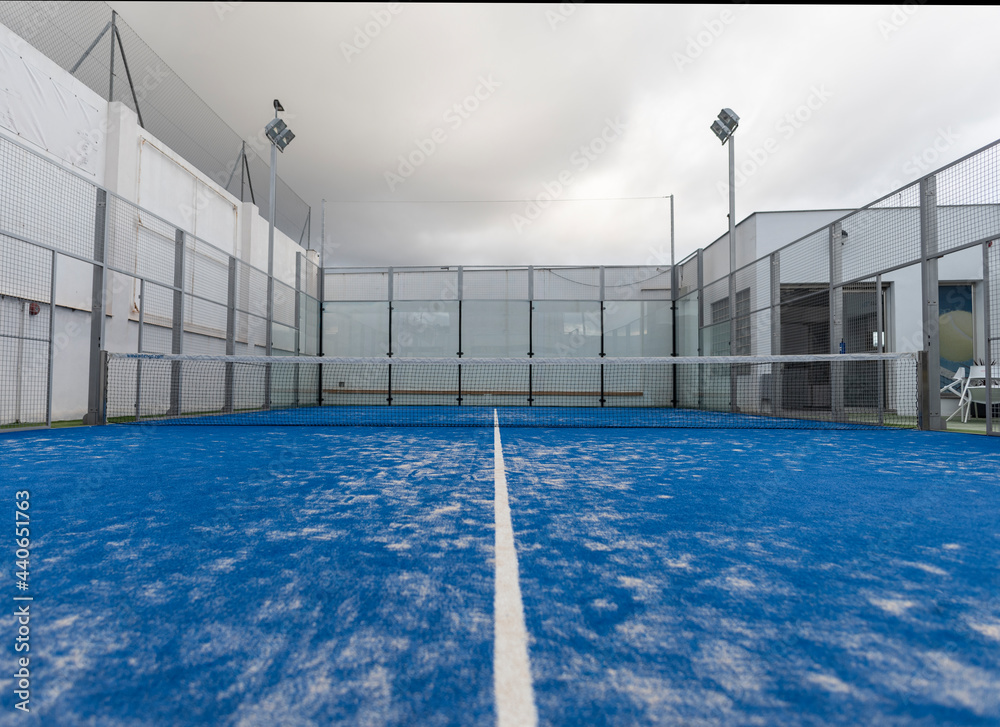 wide angle image of blue paddle tennis court without people