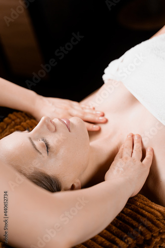 Neck and face massage in the spa. Beauty treatments for an attractive female model. Relaxation 