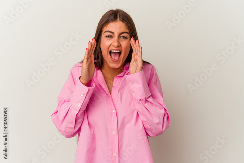 Young caucasian woman isolated on white background shouting excited to front.