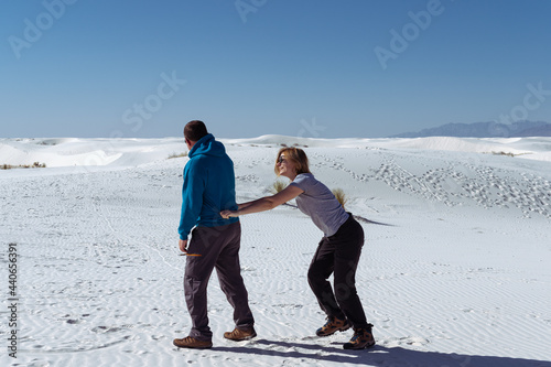 Vertical photo of a flirting couple in the desert of White Sands National Park, NM, USA